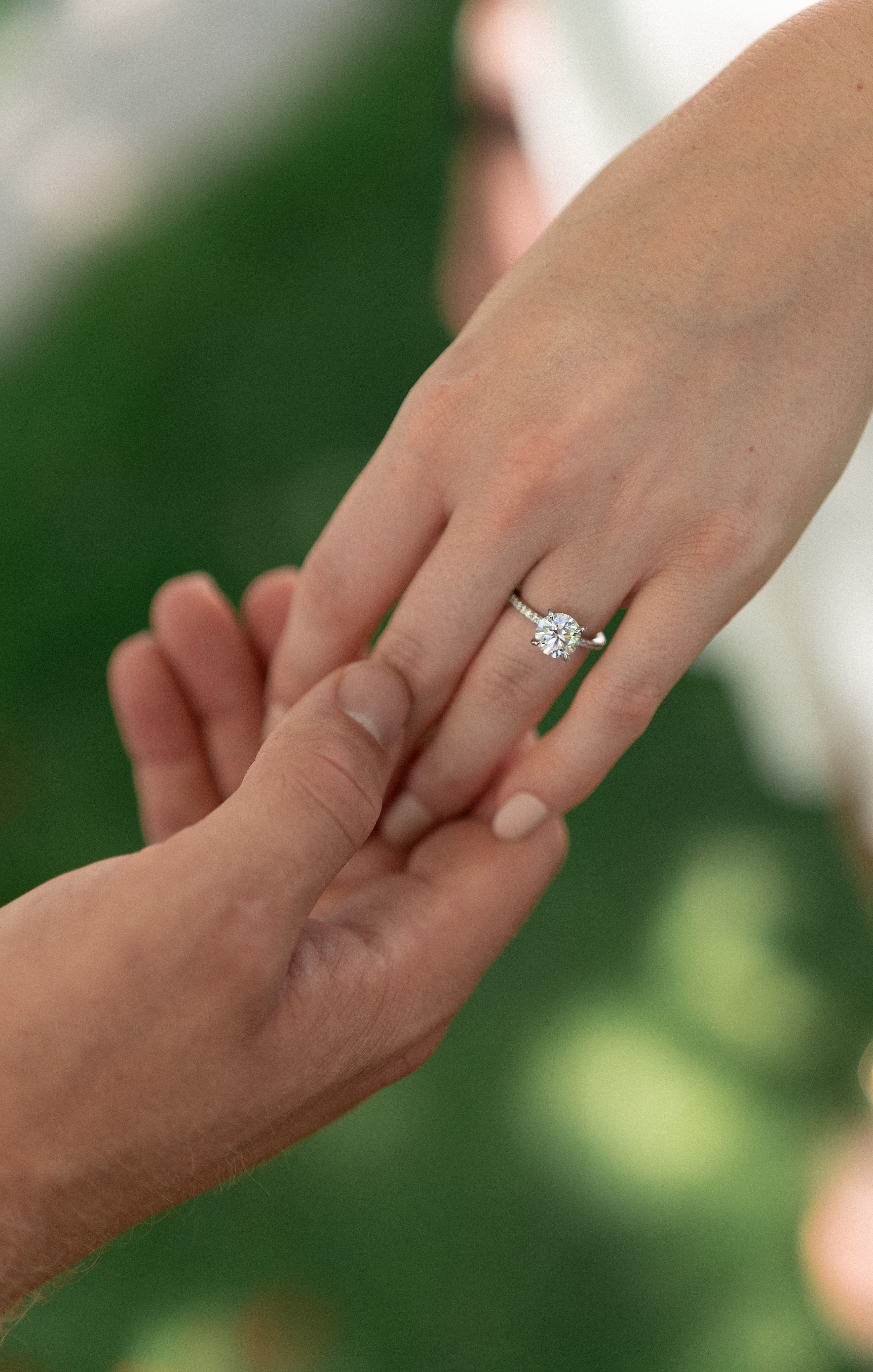 detail shot of engagement ring with green grass in the background shot by an Indianapolis wedding and couples photographer
