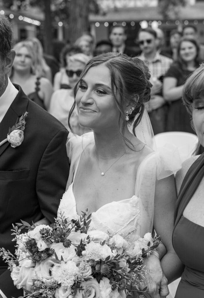 bride crying as she walks down the aisle at lizton lodge after seeing her soon to be husband for the first time