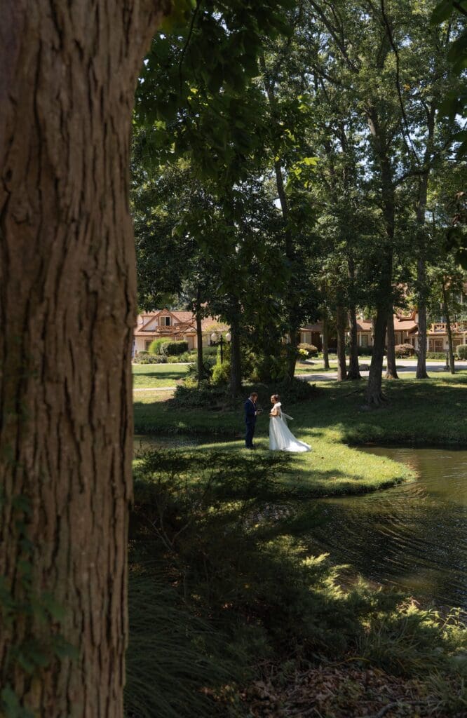 bride and groom exchanging private vows in in front of the gorgeous Lizton Lodge wedding venue pond platform